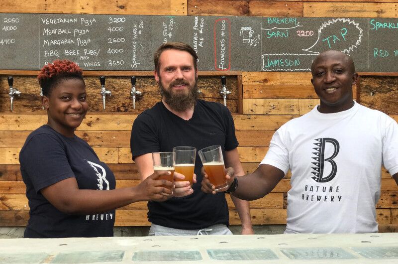 Kevin Conroy (middle), with Bature Brewery's quality control supervisor, Peace Onwuchekwa (left), and head of brewing, Bayo Ijasan (right).